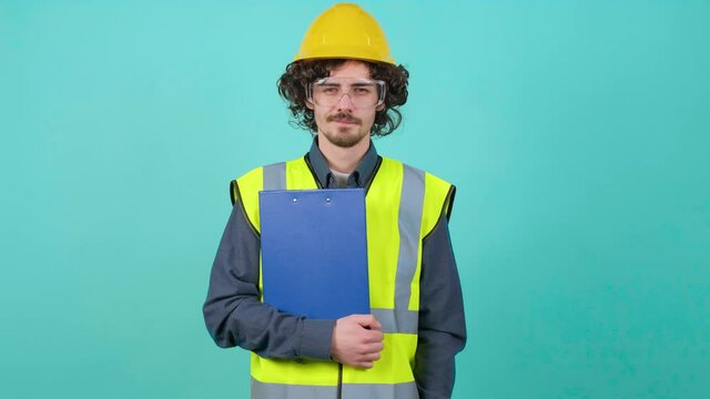 Construction worker with safety glasses and helmet that is looking at camera.