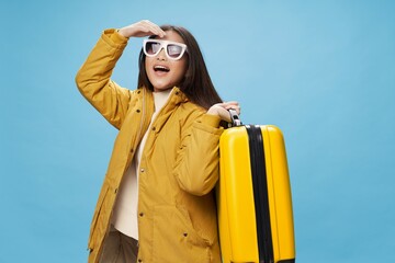 cheerful asian woman with suitcase travel winter jacket