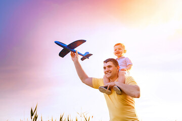 happy father with son playing with toy plane. dream to be a pilot