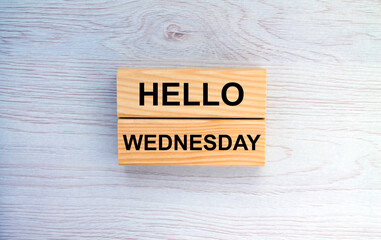 Wooden blocks with text Hello Wednesday on the wooden background
