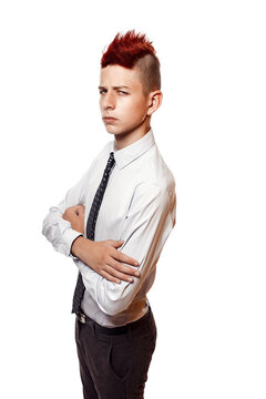 Portrait of serious teen with red mohawk wearing shirt and tie while looking at camera. Isolated.