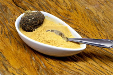 Peruvian maca roots or Peruvian ginseng (lat. Lepidium meyenii) with maca products (maca powder) on...