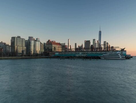 Downtown Manhattan from Hudson river in day to night time lapse