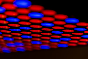 Abstract background of red and blue LED lights. The colourful texture of round shapes on black...