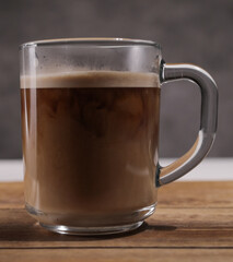 Pour milk into a freshly brewed cup of coffee - studio photography
