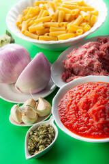 Ingredients for cooking tortiglioni bolognese pasta