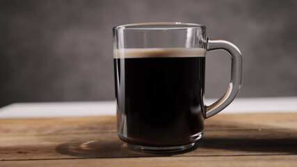 Pour milk into a freshly brewed cup of coffee - studio photography