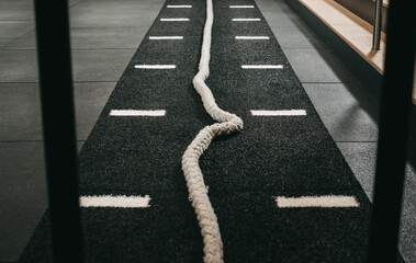 Gym rope laying on gym track