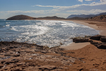 Fototapeta na wymiar Magnificent red sand beach located within Calblanque Regional natural Park, Murcia, Spain