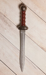 Roman Gladius on a White Wooden Table