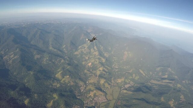 Skydiver jump over the Paraty beach. Fish eye lens. (Distorted image)