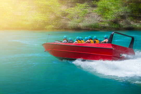 Riding people on a speedboat on a river at high speed. Motion blur effect.