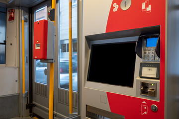Selective focus view at ticket machine inside light rail tram in Düsseldorf, Germany.