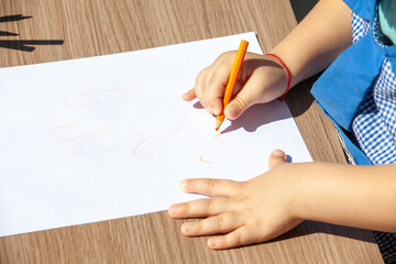 Obraz na płótnie Canvas children's hands with a pencil