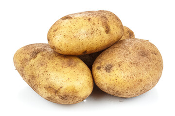 Unwashed ripe potatoes in heap isolated on white background
