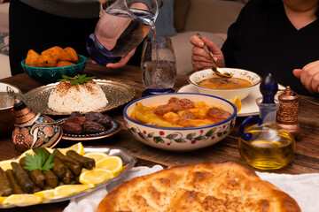Traditional Turkish dinner include pilaf (boiled rice), lentil soup, Izmir meat balls with potatoes, sarma, kibbeh (aka icli kofte), dried date fruits. Ramadan iftar (evening meal after fasting).