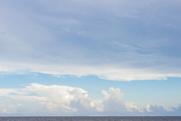 Seascape. Beautiful blue sky with clouds over the ocean. Summer background