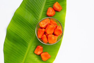 Ripe red Jackfruit on banana leaf on white