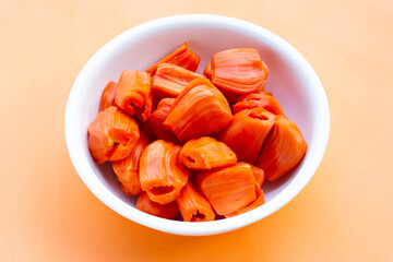 Ripe red Jackfruit on orange background.