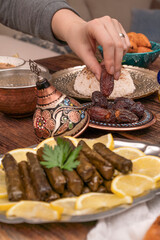 Traditional Turkish dinner include pilaf (boiled rice), lentil soup, Izmir meat balls with potatoes, sarma, kibbeh (aka icli kofte), dried date fruits. Ramadan iftar (evening meal after fasting).