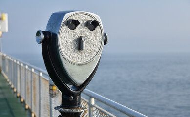 Coin operated tourist binoculars on a ferry boat.  Copy space.