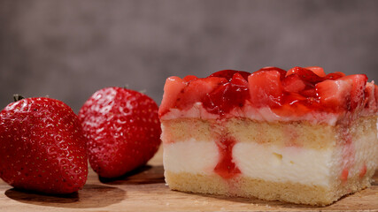 Fresh strawberry cake with cream in close-up - studio photography