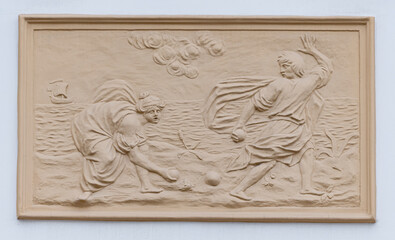 Frescoes, stucco on the facade of the building, city street