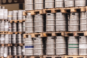 Beer barrels. Beer factory. Beer warehouse. Racks of beer barrels on pallets.