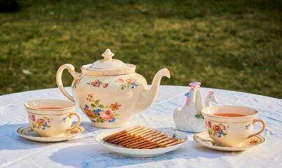 cup of teaAfternoon tea time in the garden.
In this image we can find a teapot and two antique...