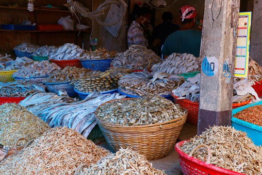 different variety of dry fishes stored in a basket for sell in a market stall