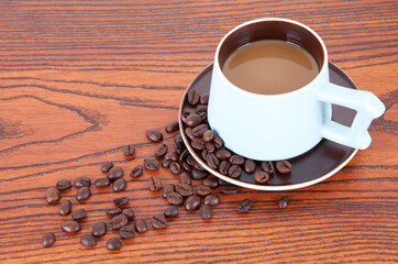 A cup of coffee and scattered beans