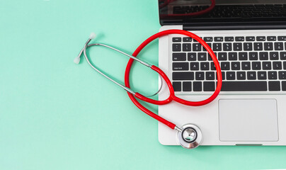 Stethoscope and laptop keyboard, computer on a wide background