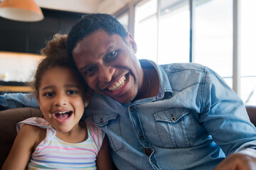 Daughter and father at home.