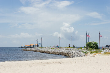 Seascape. Wooden pier with gazebos with orange roofs. Summer background. Ken Combs Pier, Gulfport,...