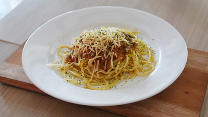 Spicy spaghetti with cheese served on the table. Photo concept for commercial use