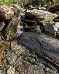 Fototapeta na wymiar small waterfall over large rocks