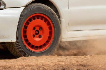 Rally race car drifting on dirt track.