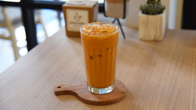 Thai tea with ice served on the table. Photo concept for commercial use