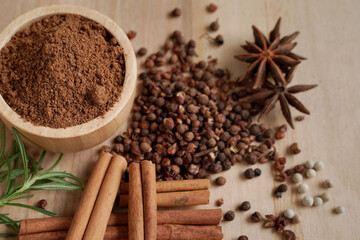 Stew powder and spices in a wooden cup with black background, industry concept