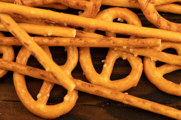 Salted breadsticks and salted pretzels scattered on the table.