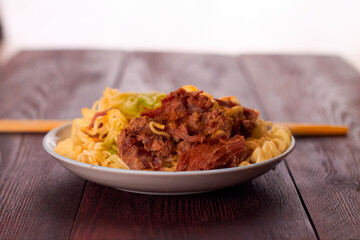 Rustic food - pot roast with chinese noodles and chopsticks