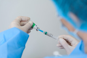 Doctor holds syringe with covishield vaccine Astrazeneca