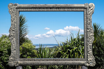 Vista viewed through large fixed frame of forest park in New Zealand