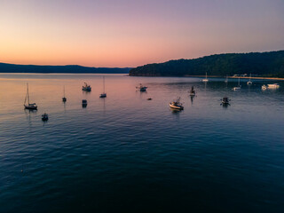 Fototapeta premium Boats at rest and gentle sunrise over the bay