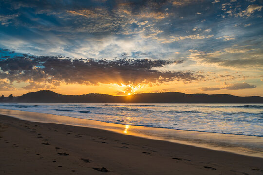 Sunrise seascape at the beach with haze and cloud