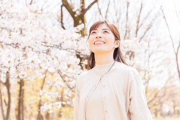 満開の桜を見上げる女性
