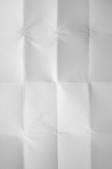 Unfolded folded white paper background in vertical