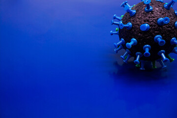 Virus model, made of sponge and map pin on a blue background.
