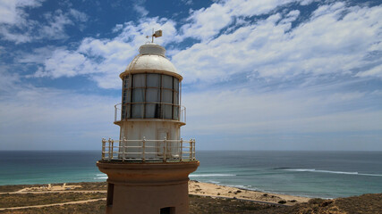 Fototapeta na wymiar Head of high old historical lighthouse at a hill next to Indian Ocean near Exmouth, Western Australia