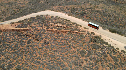 Aerial - School bus on desert road near Exmouth, Western Australia